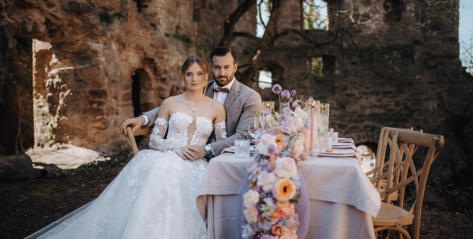 Gedeckte Hochzeitstafel mit Kerzen und heller Leinentischwäsche